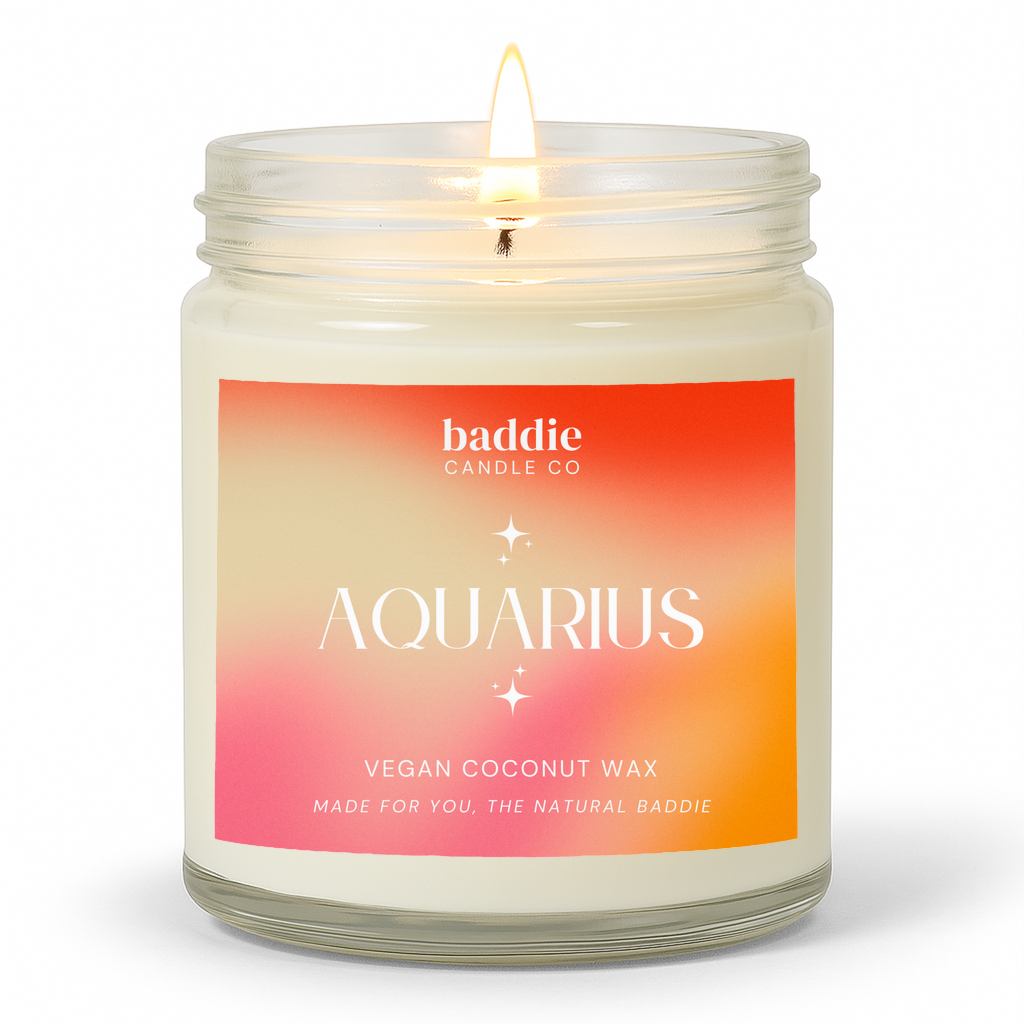 A clear jar candle with a colorful pink hued gradient label with the text, AQUARIUS, Vegan Coconut Wax, by Baddie Candle Co.