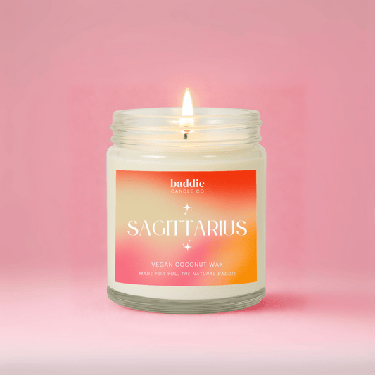 Candle with 'Sagittarius' label on a pink background