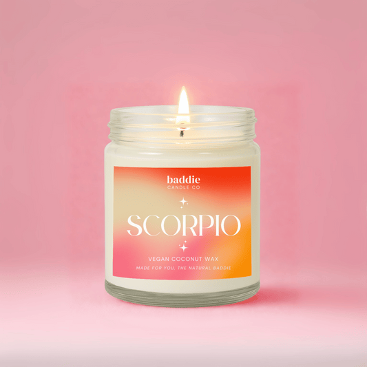 Candle in a jar with 'baddie candle co' and 'SCORPIO' label on a pink background