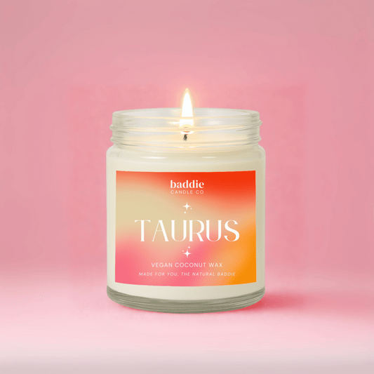 Candle with a 'taurus' label on a pink background