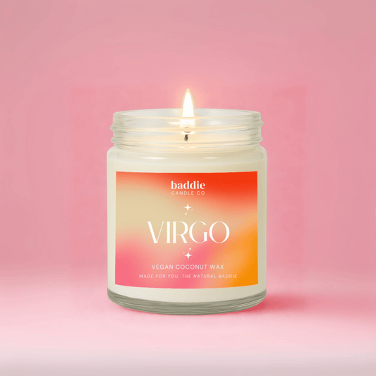 Candle in a jar with a 'Virgo' label on a pink background