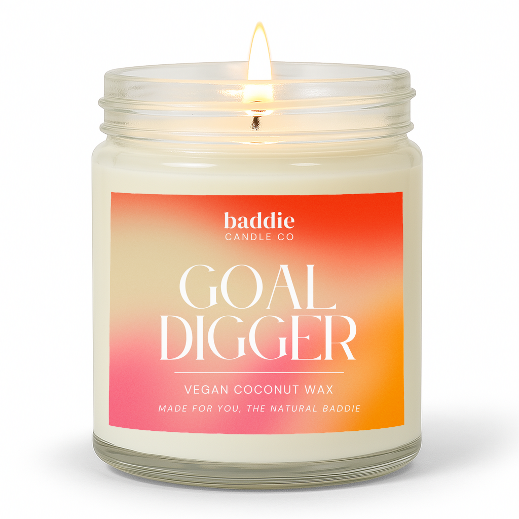 Candle in a clear glass jar with a colorful gradient 'Goal Digger' label with a white background
