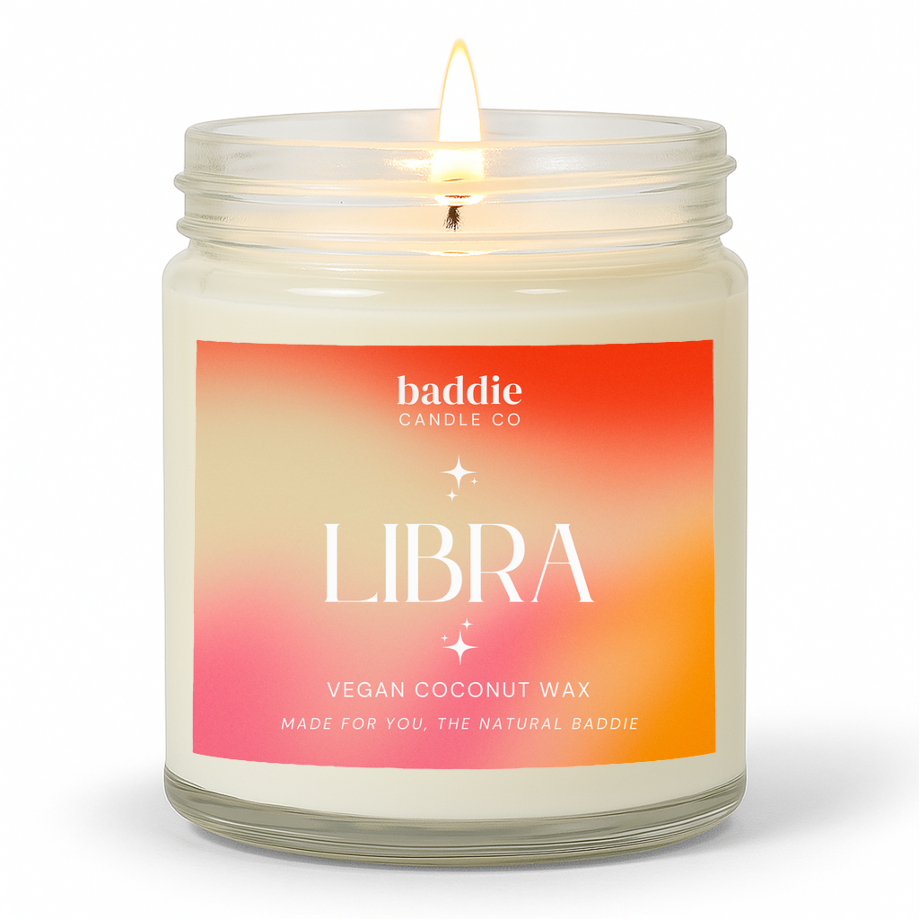 A clear jar candle with a colorful pink hued gradient label with the text, LIBRA, Vegan Coconut Wax, by Baddie Candle Co.
